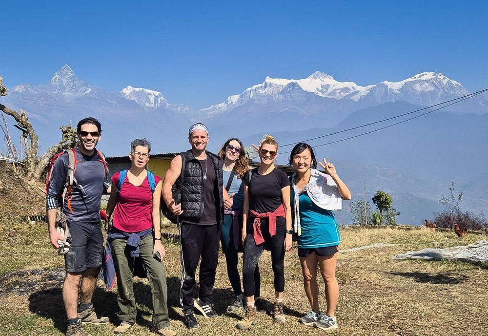 Guests on a trek with the Annapurna range behind
