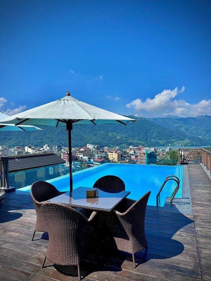 The rooftop infinity pool overlooking Pokhara and Phewa Lake
