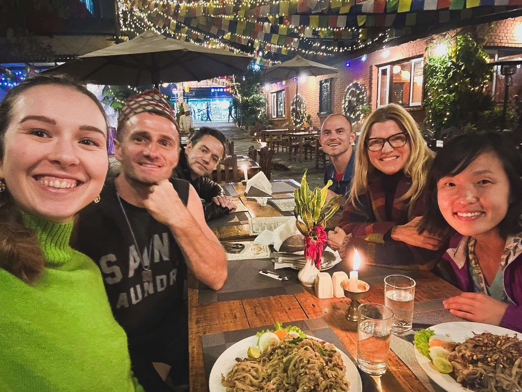 Digital nomads sharing a meal of Dal Bhat and momos in Pokhara